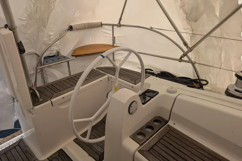 Slide: The Image of Steering area of 2007 Elan Impression 434 yacht with wooden accents and white wheel. - 9