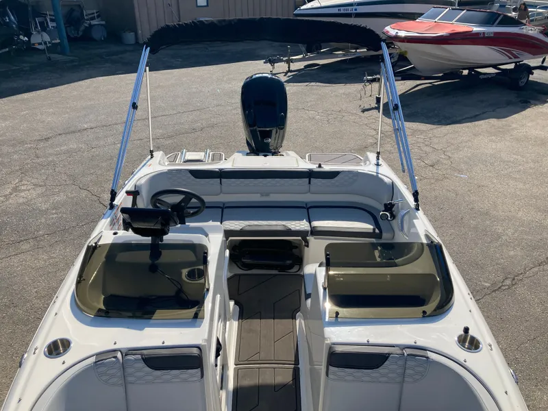 Slide: The Image of 2022 Bayliner Element M17 boat with open deck and Bimini top. - 17