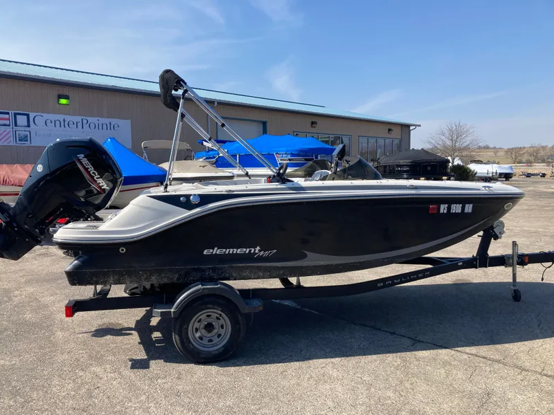 Slide: The Image of 2022 Bayliner Element M17 boat on trailer in front of building. - 4