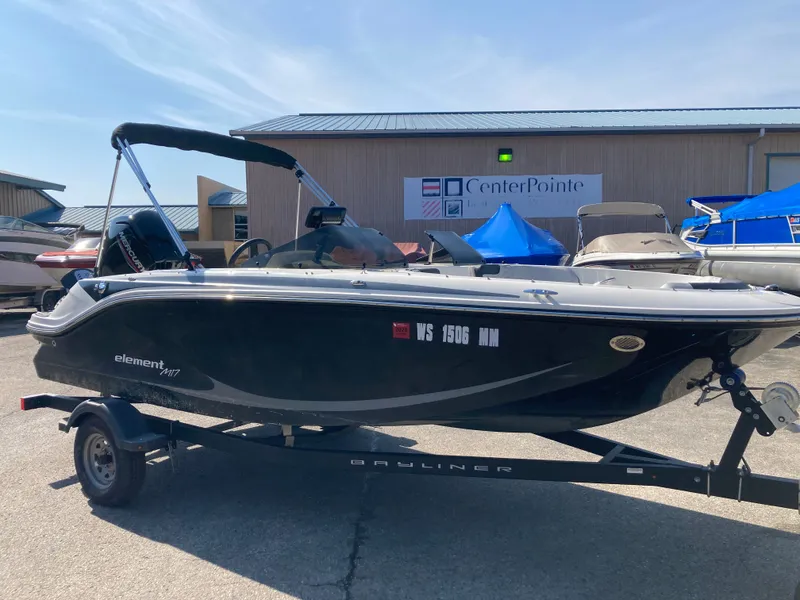 Slide: The Image of 2022 Bayliner Element M17 boat on trailer in front of building. - 5