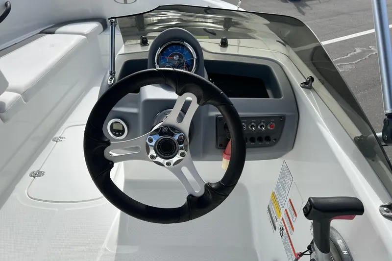 Slide: The Image of Steering console of 2021 Tahoe T16 boat with gauges and controls. - 10