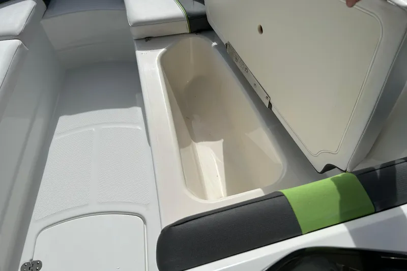 Slide: The Image of 2021 Tahoe T16 boat interior with open storage compartment and cushioned seating. - 13