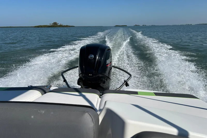 Slide: The Image of 2021 Tahoe T16 boat cruising on open water with visible wake trail. - 21