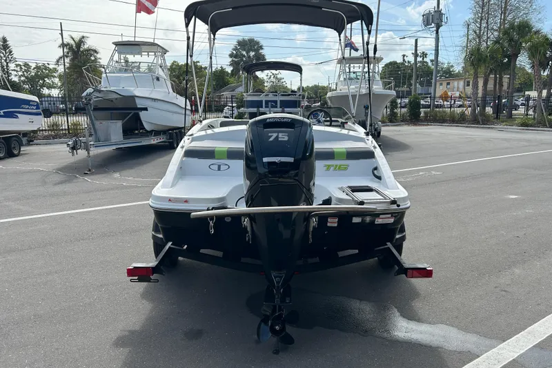 Slide: The Image of 2021 Tahoe T16 boat with Mercury 75 engine, parked in a marina. - 3