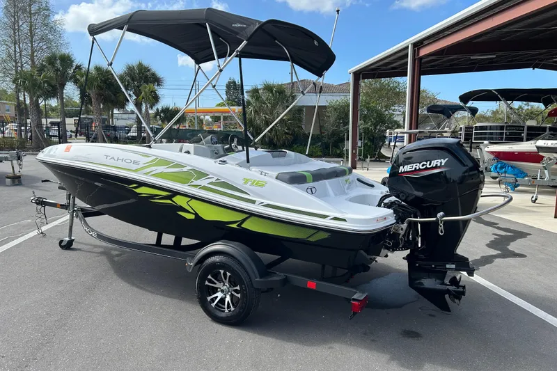 Slide: The Image of 2021 Tahoe T16 boat with Mercury engine, parked outdoors under a clear sky. - 4