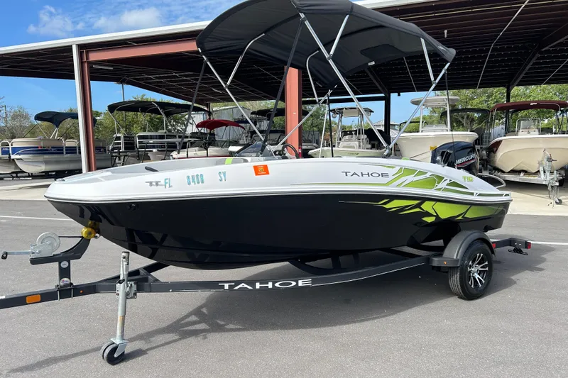 Slide: The Image of 2021 Tahoe T16 boat with canopy on trailer, parked in marina. - 5