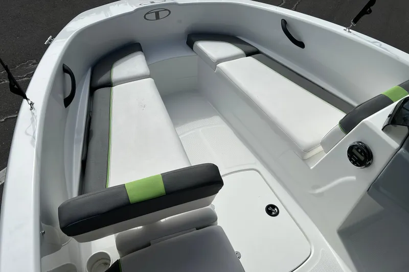 Slide: The Image of 2021 Tahoe T16 boat interior with white and green cushioned seating. - 8