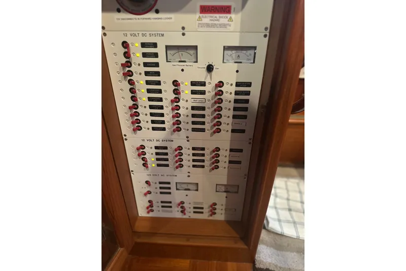 Slide: The Image of Electrical panel of a 2000 Island Gypsy 36 boat, featuring 12V and 120V systems. - 16