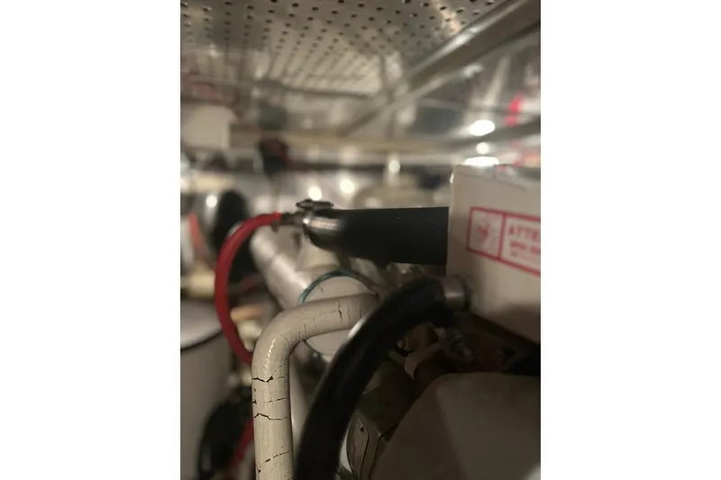 Slide: The Image of Engine room of 2000 Island Gypsy 36 with visible wiring and components. - 17