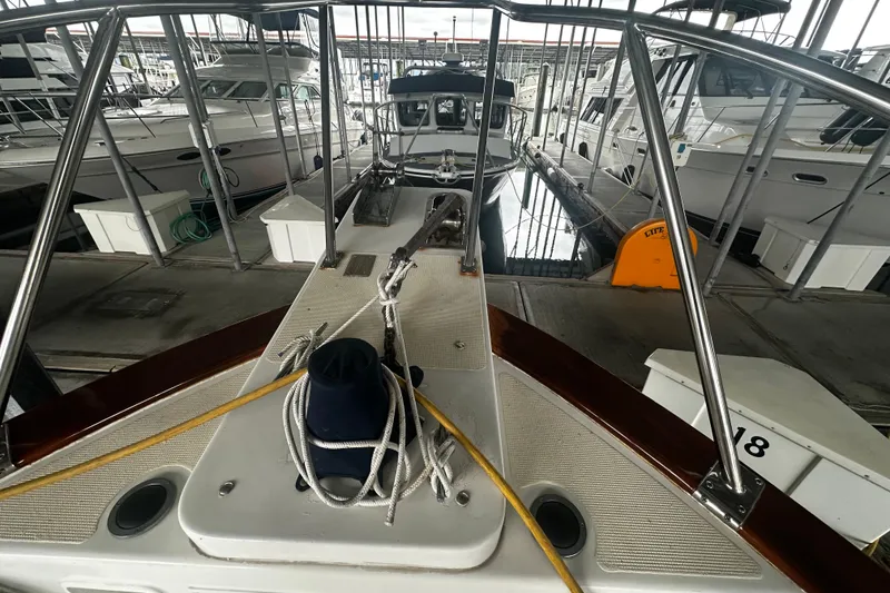 Slide: The Image of Bow view of 2000 Island Gypsy 36 yacht docked in marina. - 2
