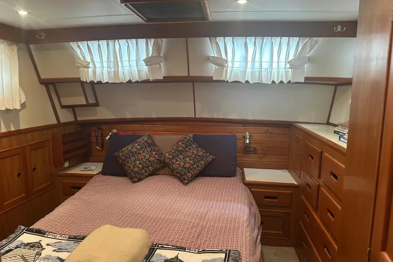 Slide: The Image of Cozy cabin interior of 2000 Island Gypsy 36 with wood paneling and bed. - 9