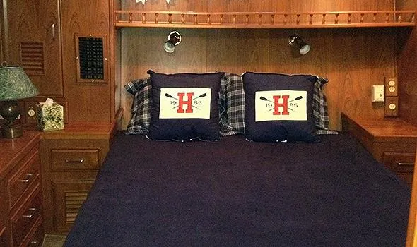 Slide: The Image of Cozy bedroom in 1986 Sea Ranger 47 Pilothouse with nautical-themed pillows and wooden cabinetry. - 13