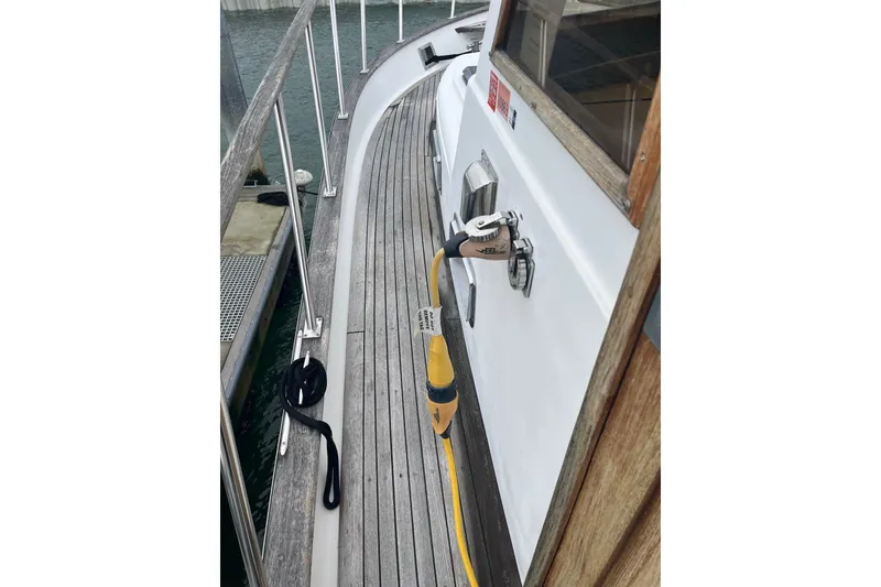 Slide: The Image of Side deck of 1986 Sea Ranger 47 Pilothouse with railing and dock connection. - 20