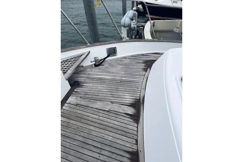 Slide: The Image of 1986 Sea Ranger 47 Pilothouse boat deck with wooden flooring and railing. - 23