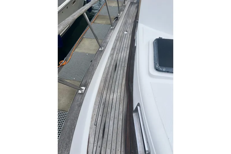 Slide: The Image of 1986 Sea Ranger 47 Pilothouse yacht deck with wooden flooring and railing. - 30