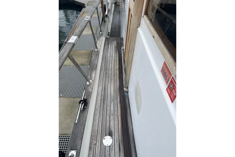 Slide: The Image of Side deck of 1986 Sea Ranger 47 Pilothouse yacht with wooden flooring and railing. - 31