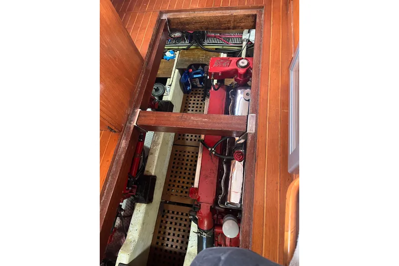 Slide: The Image of Engine compartment of a 1986 Sea Ranger 47 Pilothouse, showcasing red engine components. - 37
