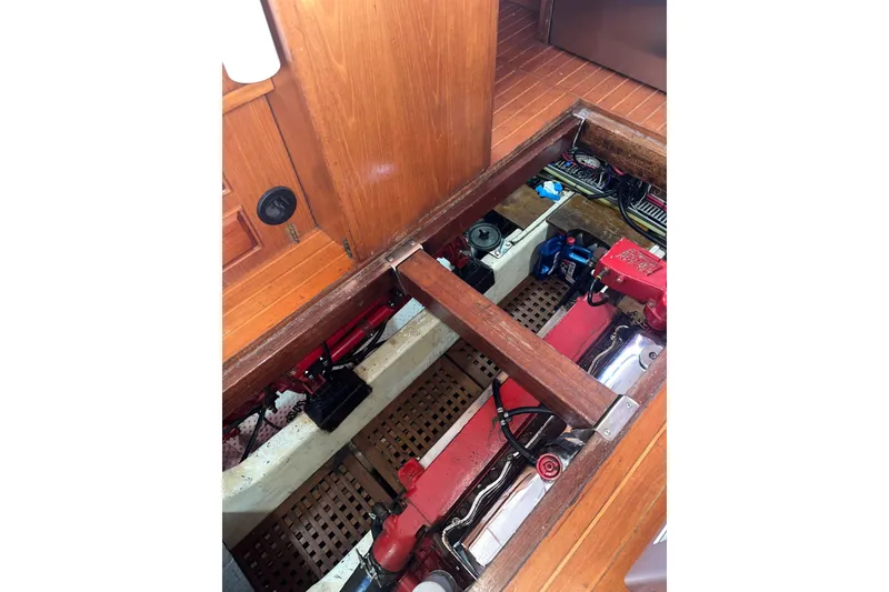 Slide: The Image of Engine room of 1986 Sea Ranger 47 Pilothouse with visible machinery and wooden flooring. - 38