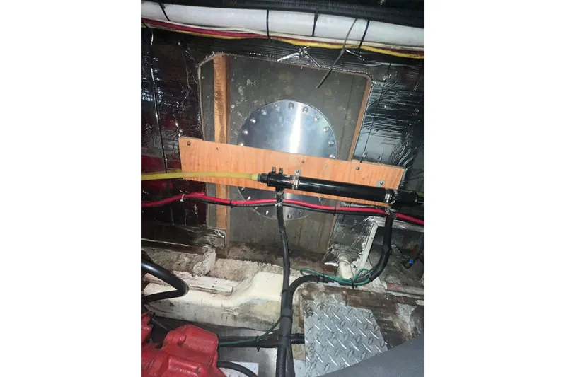 Slide: The Image of Engine room of 1986 Sea Ranger 47 Pilothouse with wiring and metal components. - 39