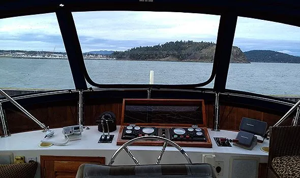 Slide: The Image of Pilothouse view from 1986 Sea Ranger 47, overlooking calm waters and distant shoreline. - 4