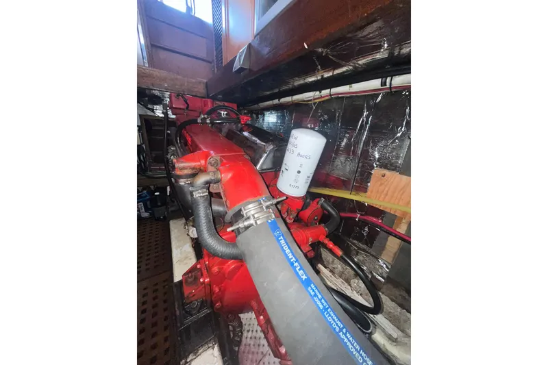 Slide: The Image of Engine compartment of 1986 Sea Ranger 47 Pilothouse with visible hoses and filter. - 41