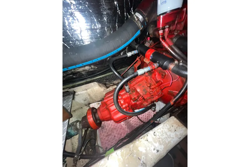 Slide: The Image of Engine compartment of a 1986 Sea Ranger 47 Pilothouse with visible red machinery. - 43