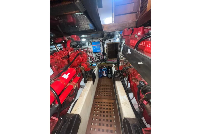 Slide: The Image of Engine room of 1986 Sea Ranger 47 Pilothouse with red machinery and equipment. - 46