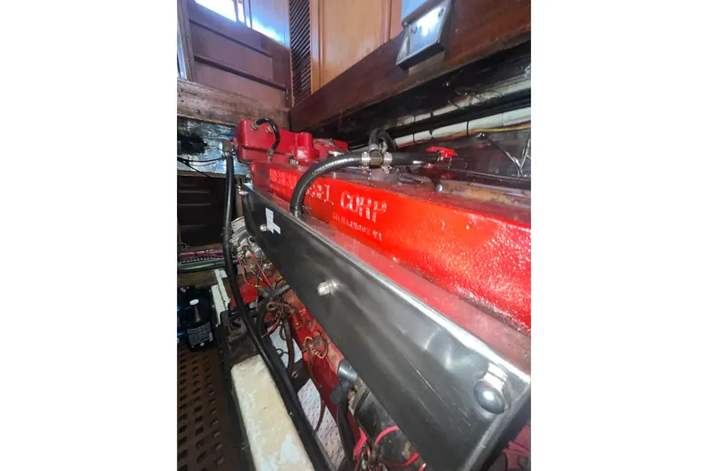 Slide: The Image of Engine room of 1986 Sea Ranger 47 Pilothouse with red engine components. - 48