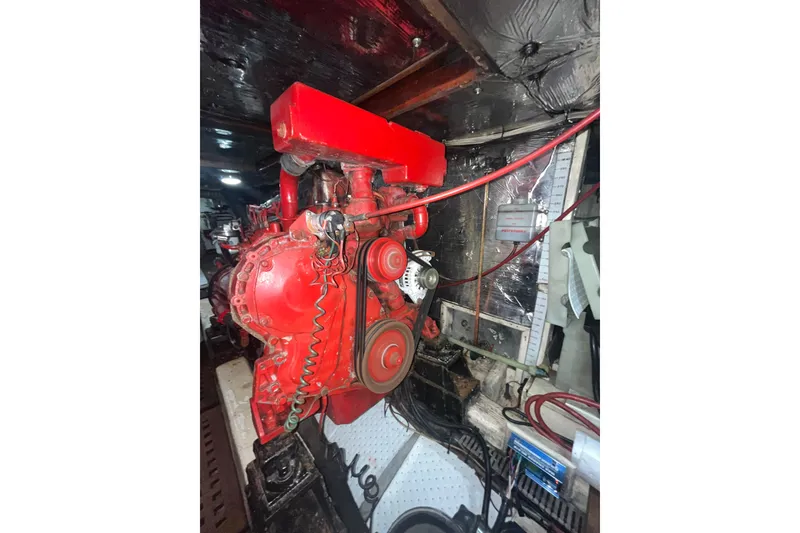 Slide: The Image of Red engine inside a 1986 Sea Ranger 47 Pilothouse boat, showcasing mechanical components. - 51