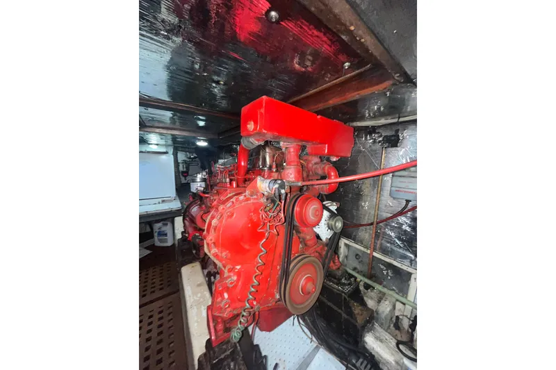 Slide: The Image of Engine room of 1986 Sea Ranger 47 Pilothouse with red machinery components. - 54