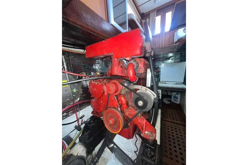 Slide: The Image of Red engine inside 1986 Sea Ranger 47 Pilothouse boat, showcasing mechanical components. - 55