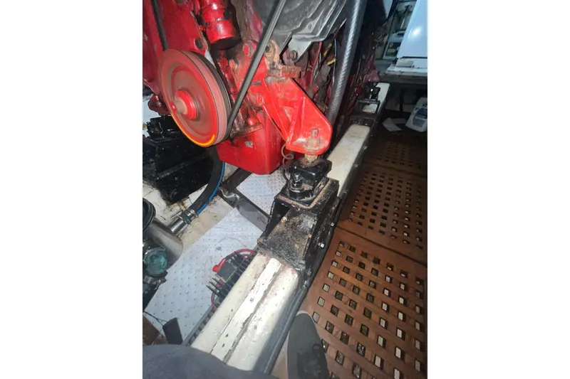 Slide: The Image of Engine compartment of a 1986 Sea Ranger 47 Pilothouse with visible red engine components. - 56