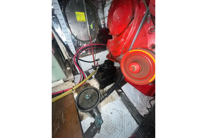 Slide: The Image of Engine compartment of a 1986 Sea Ranger 47 Pilothouse with visible red engine components. - 57
