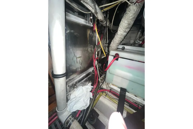 Slide: The Image of Engine room of 1986 Sea Ranger 47 Pilothouse with wiring and components visible. - 60