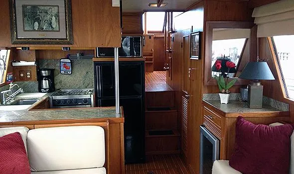 Slide: The Image of Interior of 1986 Sea Ranger 47 Pilothouse with kitchen and cozy seating area. - 7