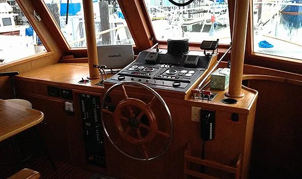 Slide: The Image of 1986 Sea Ranger 47 Pilothouse interior with wooden helm and navigation controls. - 8
