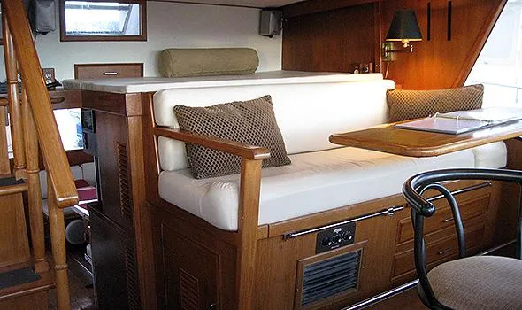 Slide: The Image of Interior of 1986 Sea Ranger 47 Pilothouse with wooden furnishings and cushioned seating. - 9
