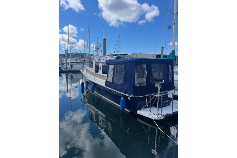 Slide: The Image of 2015 Ranger Tugs R-31 S docked at marina under blue sky. - 7