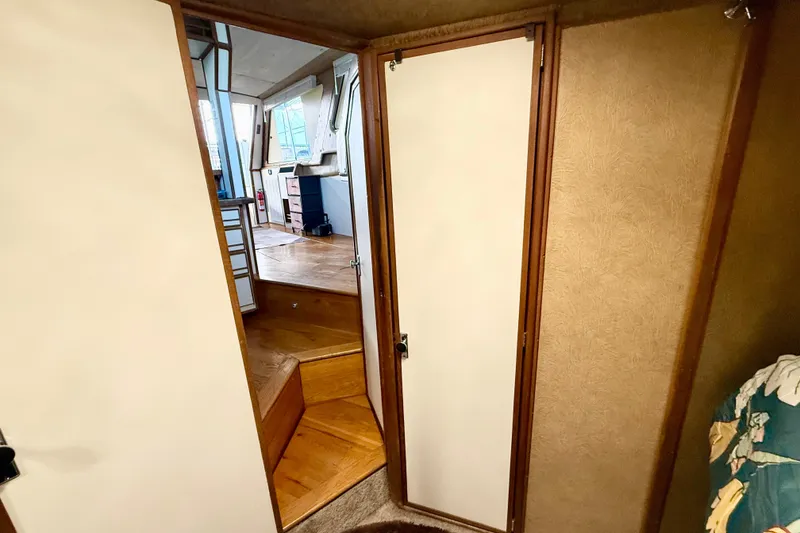 Slide: The Image of Interior view of 1982 Sea Ray 355T Trawler, featuring wooden steps and cabin doorway. - 10