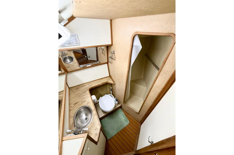 Slide: The Image of 1982 Sea Ray 355T Trawler bathroom with sink, toilet, and shower. - 13