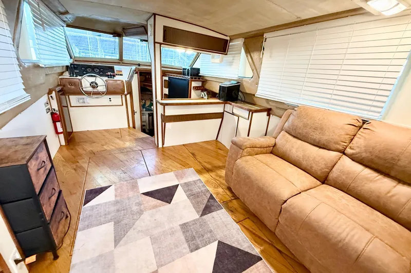 Slide: The Image of Interior of 1982 Sea Ray 355T Trawler with cozy seating and helm station. - 19