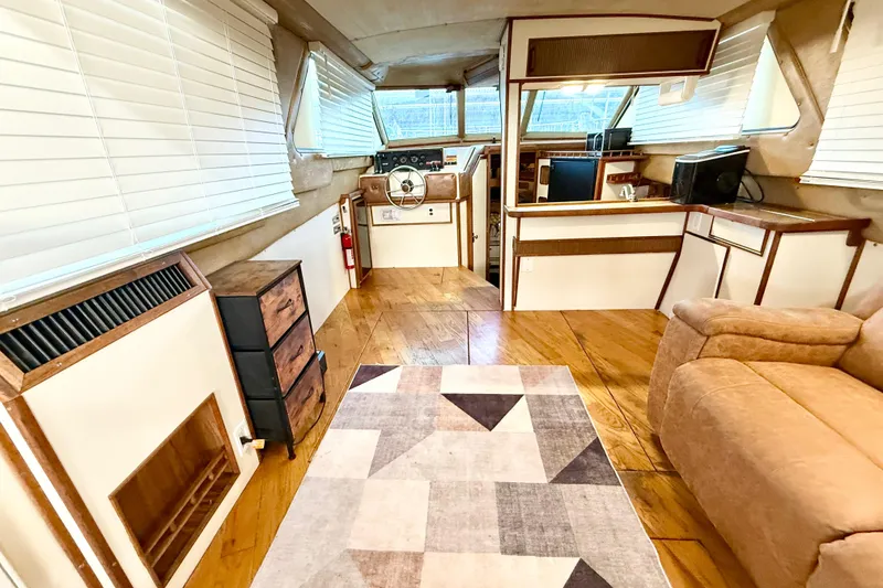 Slide: The Image of Interior of 1982 Sea Ray 355T Trawler with wood flooring and modern furnishings. - 20