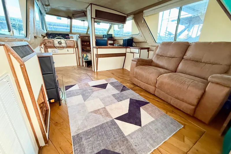 Slide: The Image of 1982 Sea Ray 355T Trawler interior with cozy seating and nautical decor. - 3