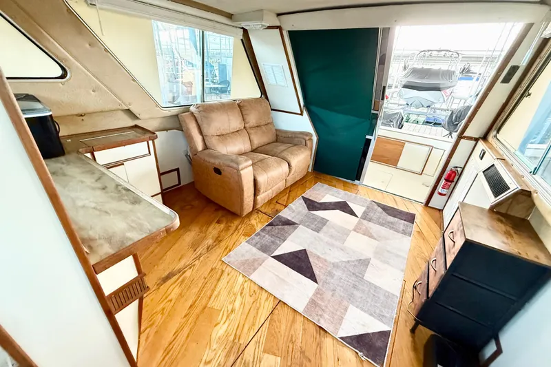 Slide: The Image of Interior of 1982 Sea Ray 355T Trawler with cozy seating and modern decor. - 6