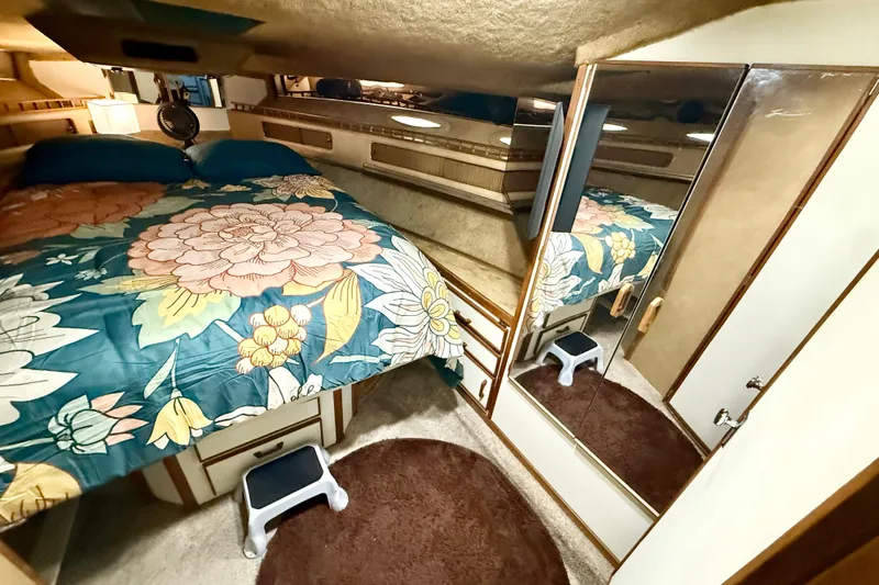 Slide: The Image of Cozy bedroom in 1982 Sea Ray 355T Trawler with floral bedding and mirrored closet. - 7