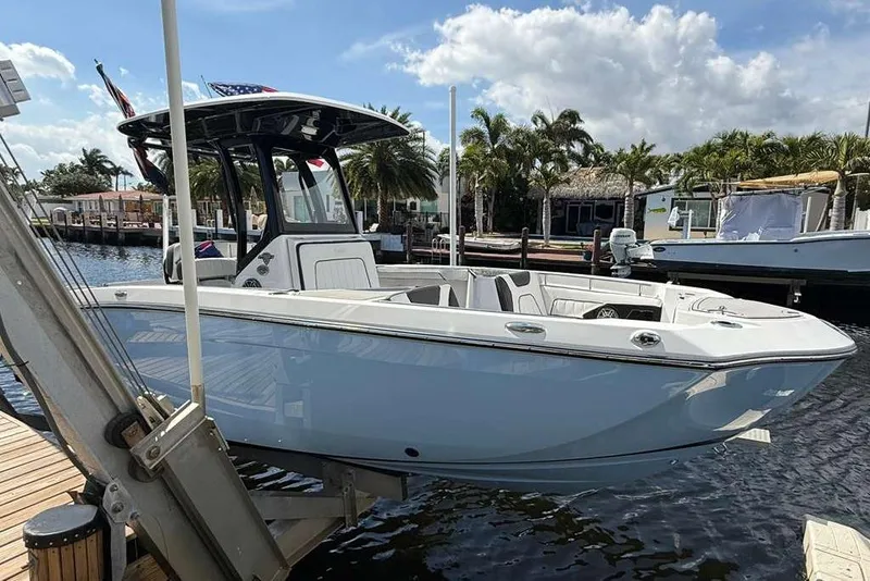 The Image of 2024 Yamaha Boats 255 FSH Sport H docked, showcasing sleek design and modern features. - 1