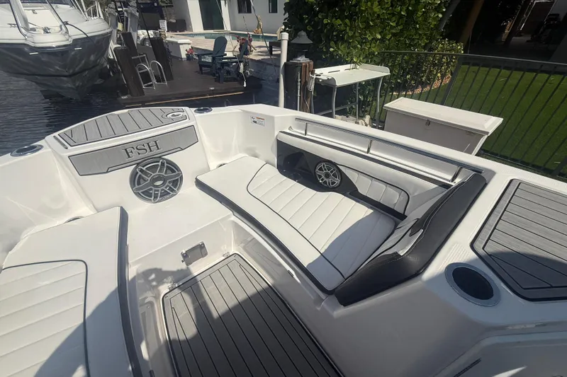 Slide: The Image of 2024 Yamaha Boats 255 FSH Sport H interior with seating and speaker system. - 10