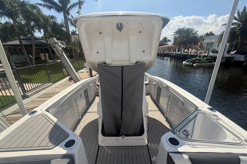 Slide: The Image of 2024 Yamaha Boats 255 FSH Sport H, docked, showcasing spacious deck and sleek design. - 13
