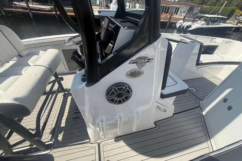 Slide: The Image of 2024 Yamaha Boats 255 FSH Sport H interior with seating and console details. - 5