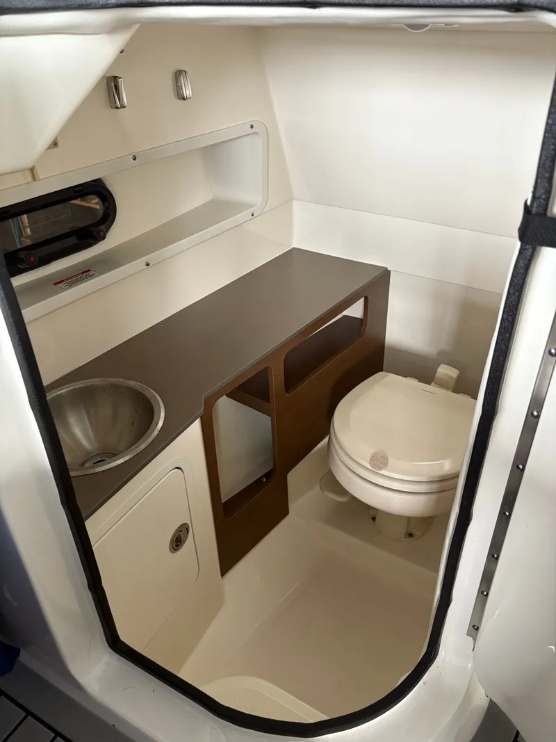 Slide: The Image of Interior of 2020 Sea Ray SDX 270 with toilet and sink. - 13